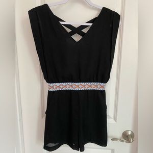 Black romper. Waist detail. Criss-cross open back. Loose fit. Size S.